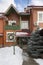 Brick cottage with decorations for the New Year. Snowing