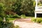 Brick Driveway Past Landscaped Garden