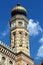 Brick exterior detail of synagogue with clock tower and onion dome