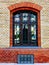 brick exterior elevation frontal view detail with arched window and reflecting glass