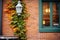 brick exterior with ivy walls and a vintage style lamppost