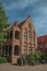 Brick facade of house in typical Flandersâ€™s style in a peaceful courtyard in Bruges.