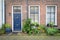 Brick Facade of Old Dutch House with flowers in pots