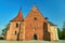 Brick facade of the Romanesque church of John of Jerusalem behind the walls