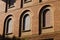 Brick facade with round arches of an old building Italy, Europe