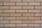 Brick facade tiles, chipped brown brick, facade texture . Noisy texture. Focus around the frame