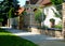 Brick fence piers with metal mesh panels. formal gareen garden and house in the background