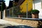 Brick fence piers with metal mesh panels. formal gareen garden and house in the background