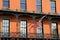 Brick front building with black railings and American flag