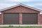Brick garage with roller shutters for two cars place