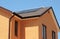 Brick house asphalt shingles roof top with solar water heater, solar water heating panels