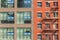 Brick house with Fire ladder and glass facade in streets in West Village, Manhattan.