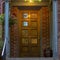 Brick house with glass paned brown wood front door