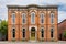 a brick italianate building focusing on its tall, rounded windows