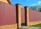 Brick and Metal Fence with Door and Gate. Fencing construction.