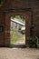 Brick opening frames the entry to the walled kitchen garden