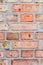 Brick orange red wall. Vertical pattern of building bricks with layers of cement