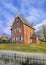 Brick parsonage against cloudy blue sky, Ravels, Flanders, Belgium