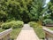 Brick path and bridge with grasses and flowers