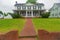 Brick pavement leading to the entrance to a classic American home