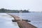 Brick pier with small lighthouse on river Daugava