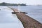 Brick pier with small lighthouse on river Daugava