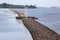 Brick pier with small lighthouse on river Daugava