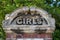 A brick pillar outside a school with the words Girls on a common site on the entrance to a school in the victorian era when