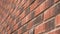 Brick red wall with uneven texture. Exterior decorative rough surface