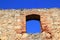 Brick segmental arch in ancient masonry stone wall