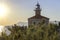 Brick ship coastal lighthouse at sunset.