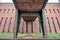 Brick and Steel Pillar of a Bridge, in front of an old Industry Building