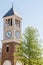 Brick and Stucco Clock Tower by Tree