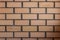 Brick symmetric wall, orange and grey colour, horizontal shot made from normal camera angle