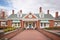 brick walkway approaching a colonial revival home with dormers