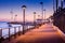 Brick walkway to boat dock in early sunrise light, streelights on, shadows, quiet, calm peaceful, Avalon, Santa Catalina Island, C