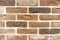 Brick wall of beige and brown bricks. Background and texture of brickwork