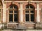 Brick wall and a bench under large windows