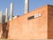 Brick wall with black and white sign for Apartheid Museum, and pillars with other conceptual words