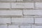 Brick wall, construction of light white bricks. The stony surface, made with your own hands during construction