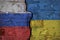 Brick wall with a crack painted on opposite sides in the Ukrainian and Russian flags