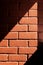 Brick wall fiery red background with light spot