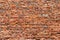 Brick wall made of old crumbling red bricks