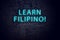 Brick wall and neon sign with inscription. Concept of learning filipino