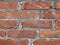 Brick wall of an old house. Rough brick. A close-up of a brick