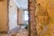 Brick wall with old paperhangings is the part of interior of apartment during on the renovation