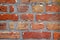 Brick wall of red color, closeup of masonry