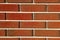 Brick wall red masonry white joints. Horizontal stone walls carmine textured bricks