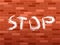 Brick wall and stop text