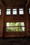 Brick wall of a tall abandoned brick building. The ruins of an industrial enterprise. Big windows